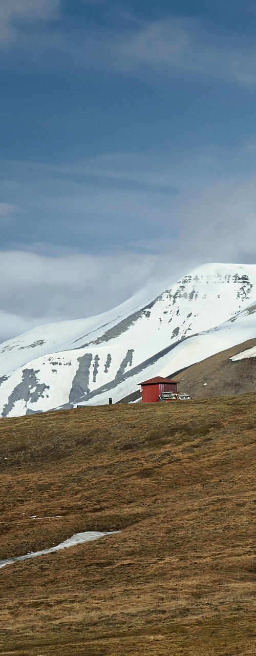 Red cabins in snowy mountain landscape