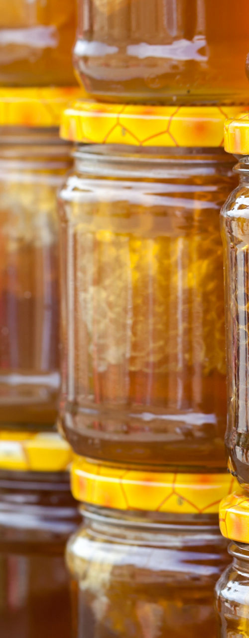 Rows of Glass Jars Filled with Natural Honey