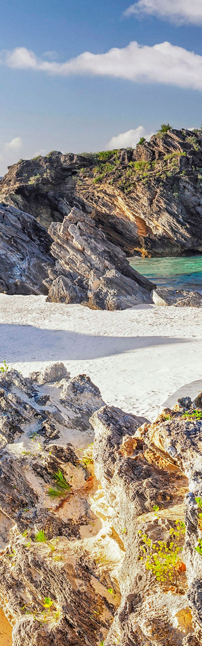 Scenic beach with rocky cliffs and clear skies