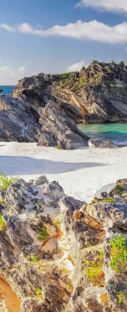 Scenic beach with rocky cliffs and clear skies