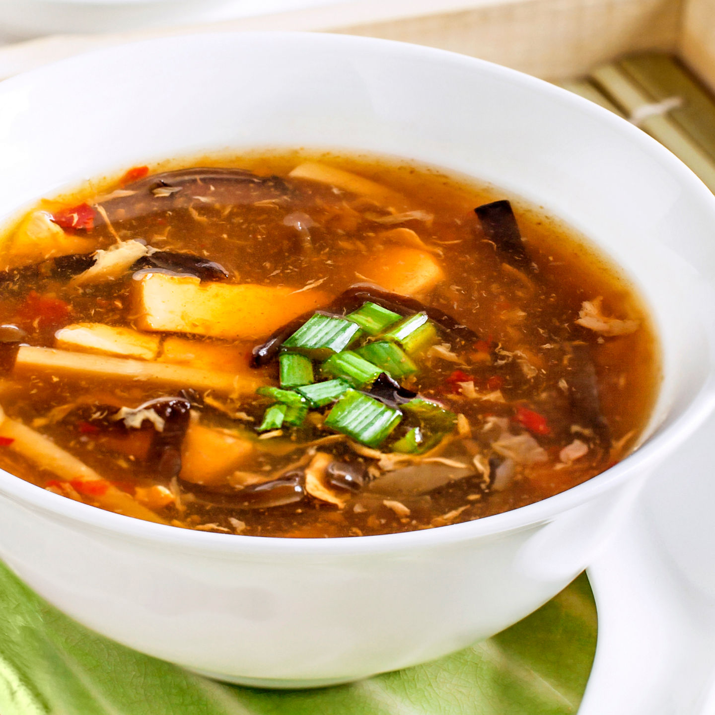 Hot and sour soup in white bowl