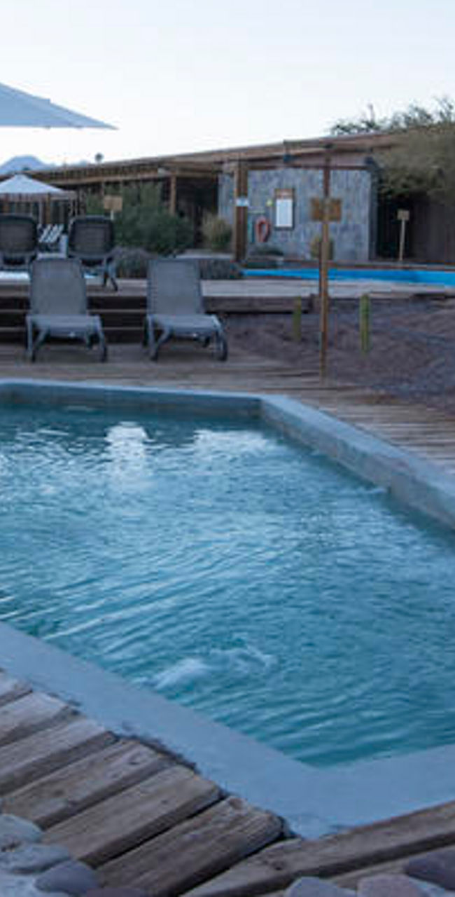 Outdoor pool with lounge chairs and umbrellas