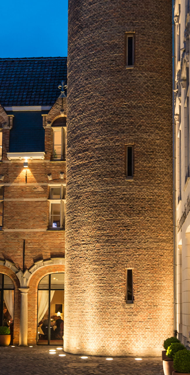 Historic castle tower at dusk with courtyard