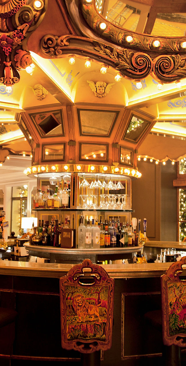 Vintage carousel-themed bar with warm lighting