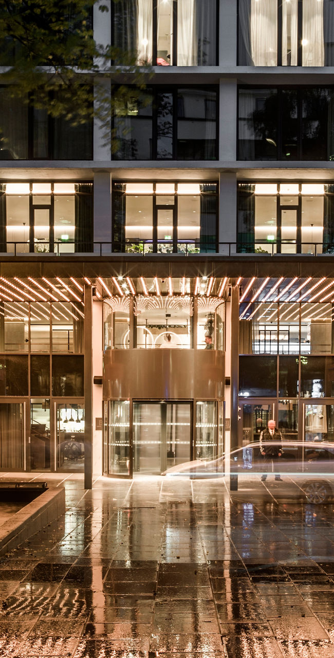 Modern building entrance at night with lights