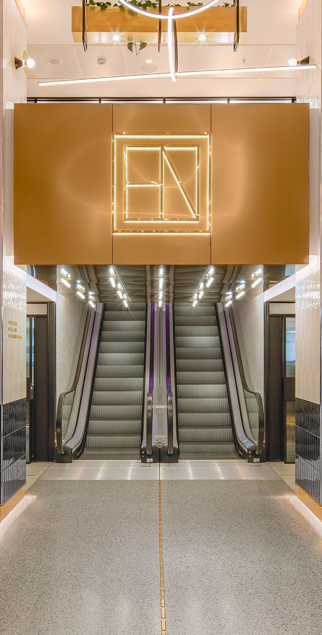 Modern lobby with escalators and seating area