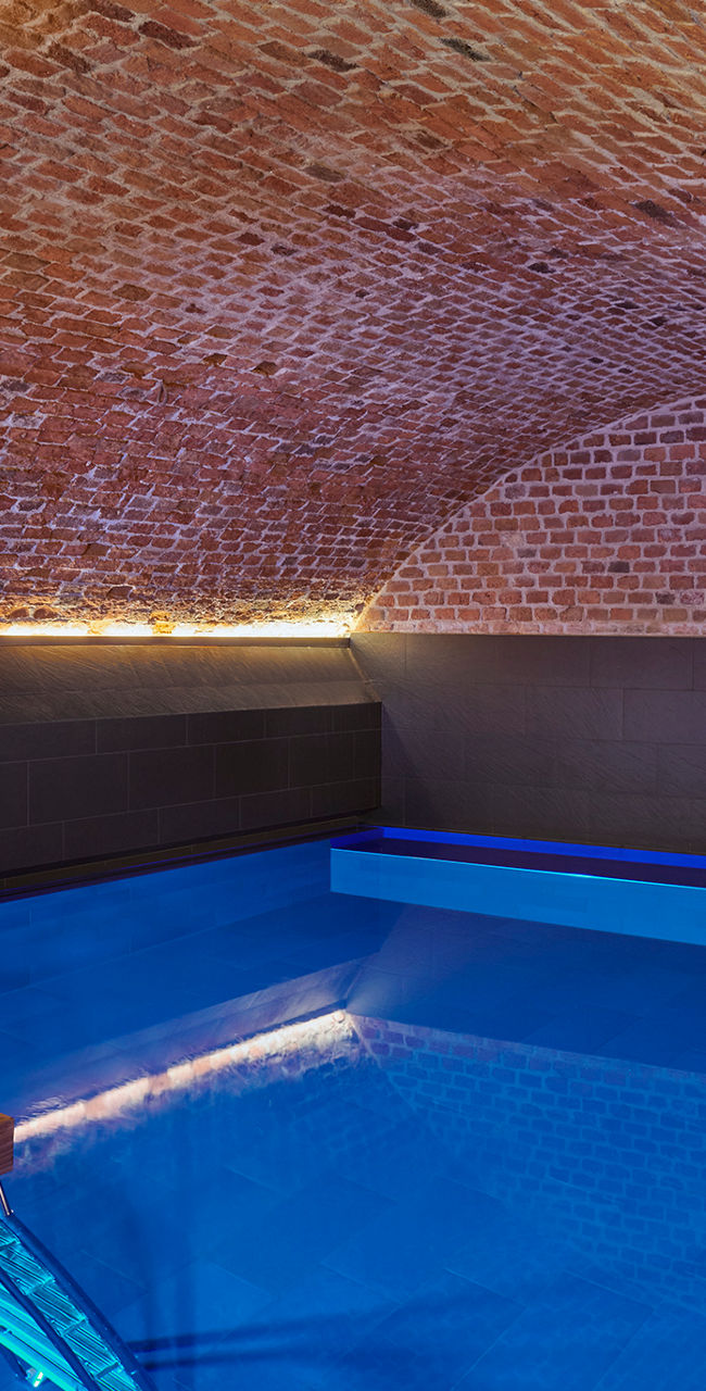Indoor pool under brick vaulted ceiling
