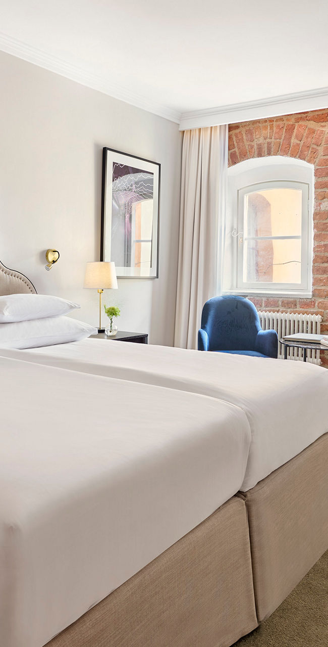 Elegant hotel room with brick accent wall