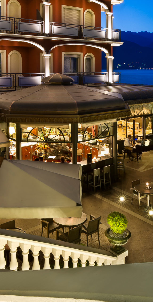 Elegant lakeside hotel terrace at dusk
