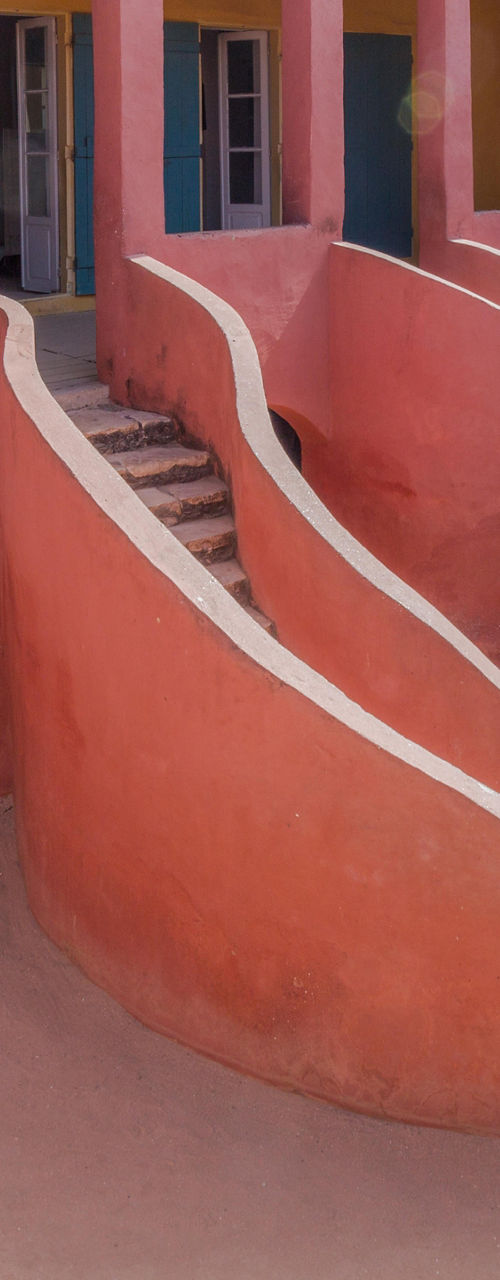 Historic pink colonial building with arches