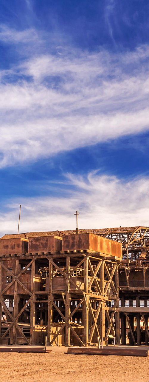 Historic industrial site under vibrant sky