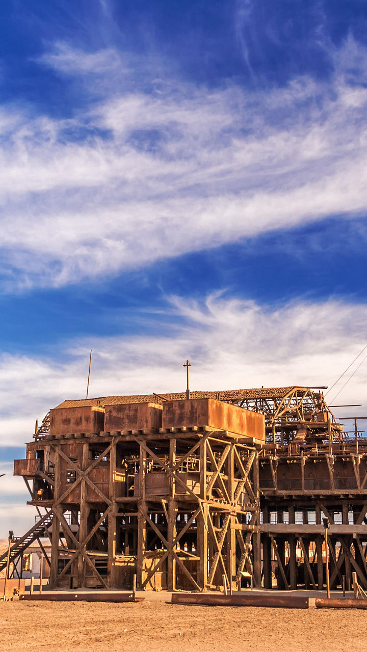 Historic industrial site under vibrant sky