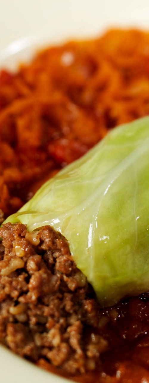 Stuffed cabbage roll on white plate