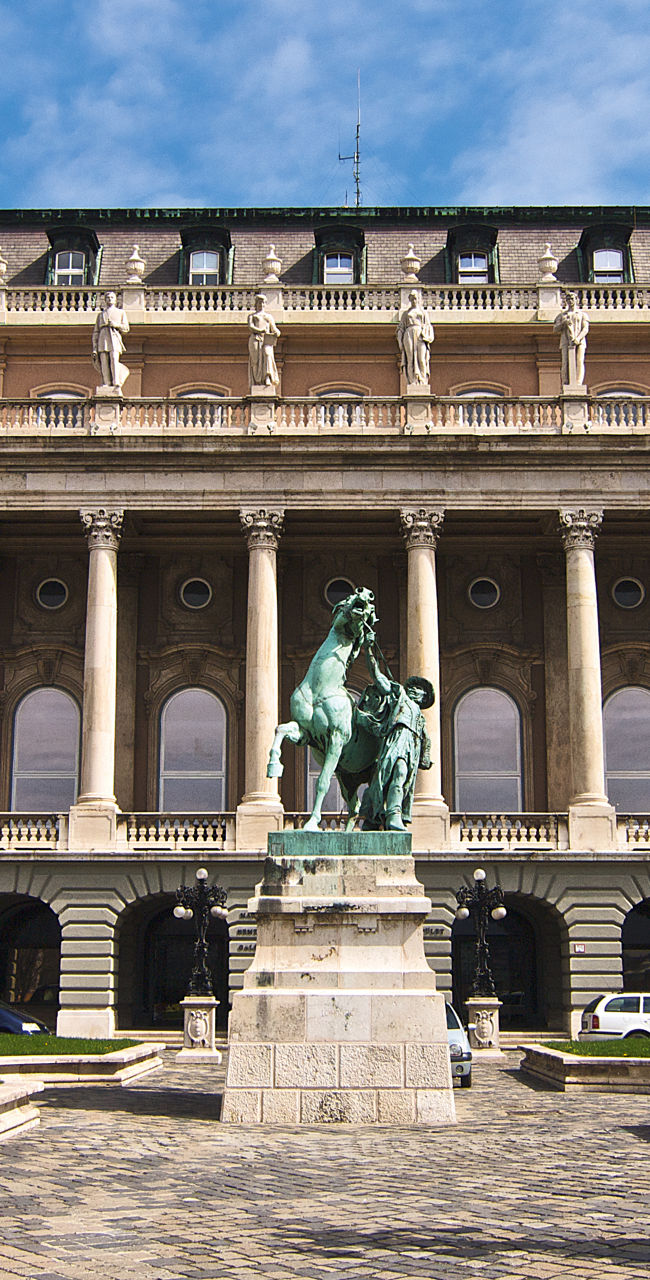 Historic palace with statue and gardens