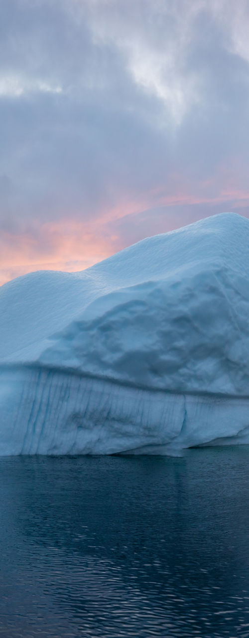 Iceberg at sunset in calm Arctic waters