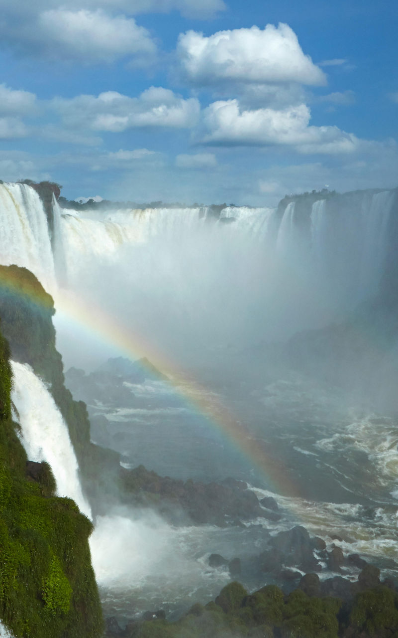 Majestic waterfall with vibrant rainbow