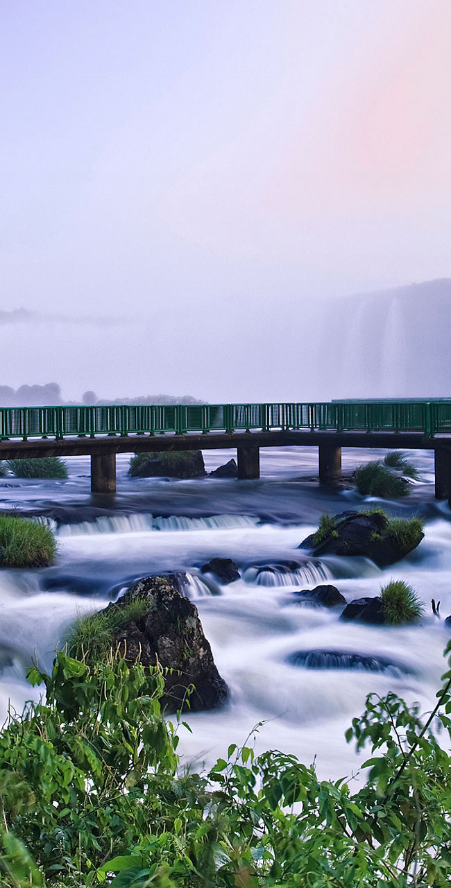 Scenic view of Iguazu Falls at sunrise