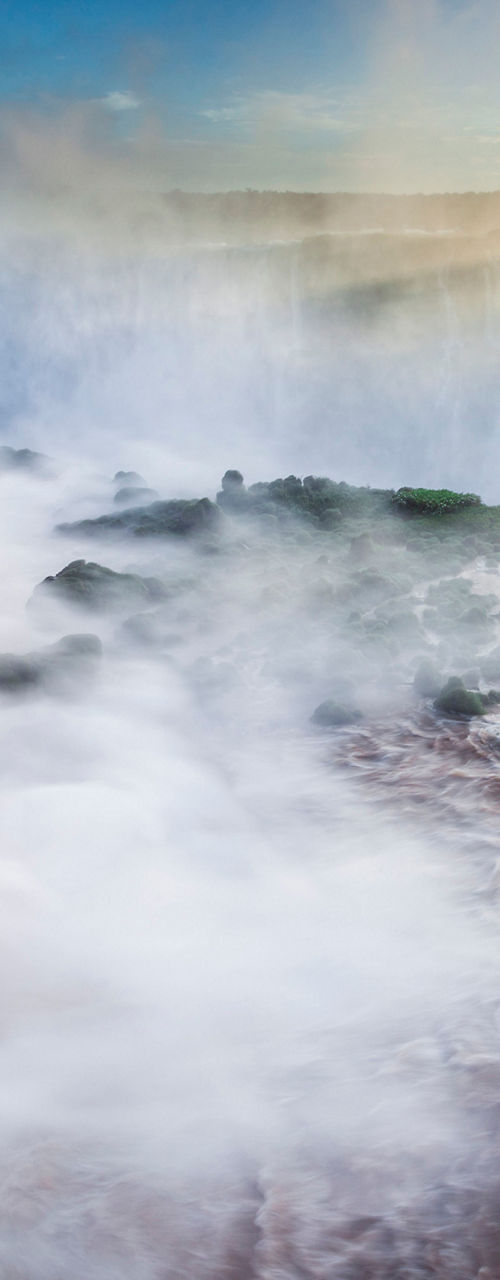 Majestic waterfall at sunrise with mist
