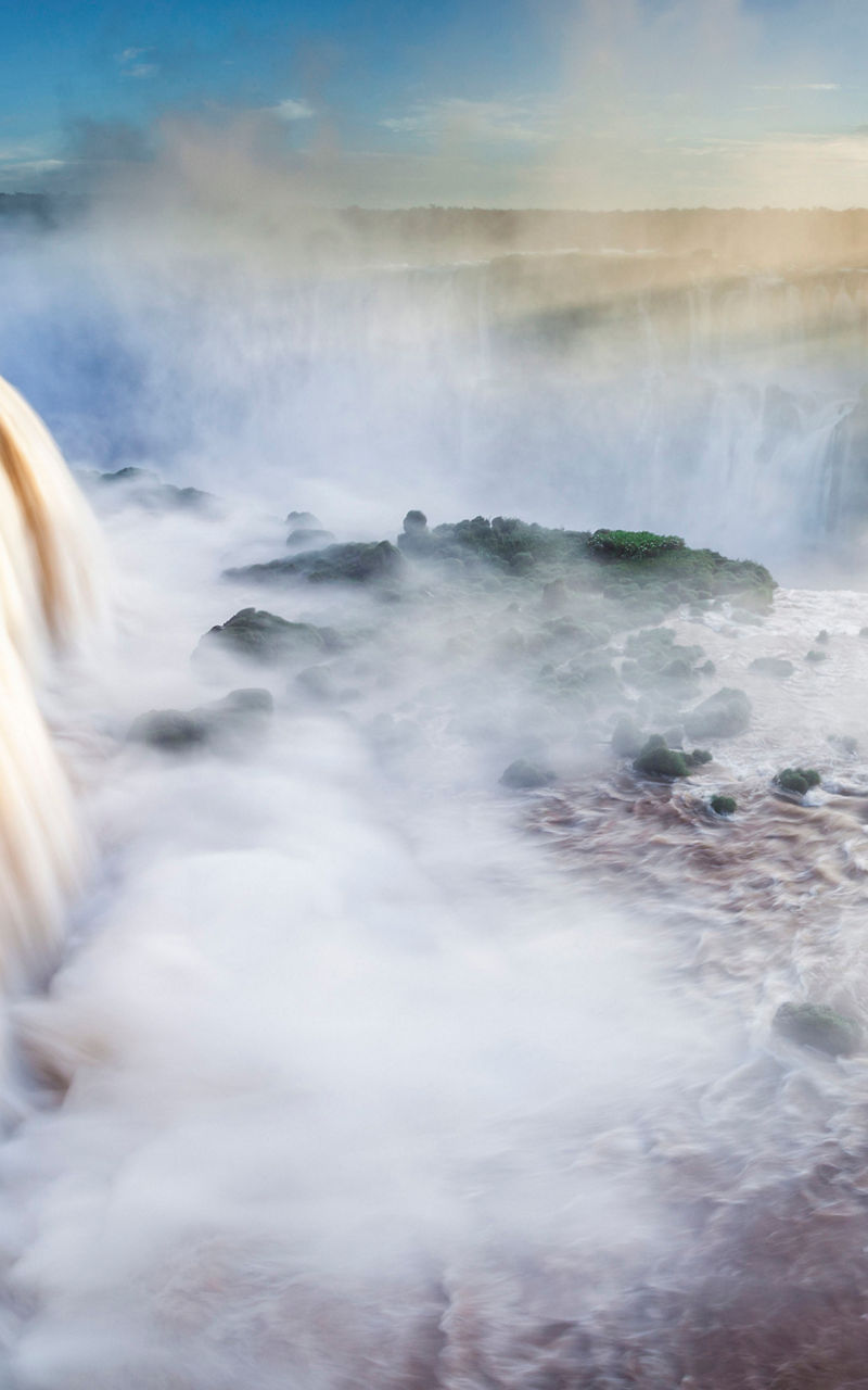 Majestic waterfall at sunrise with mist