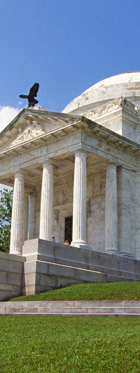 Historic white marble memorial under blue sky