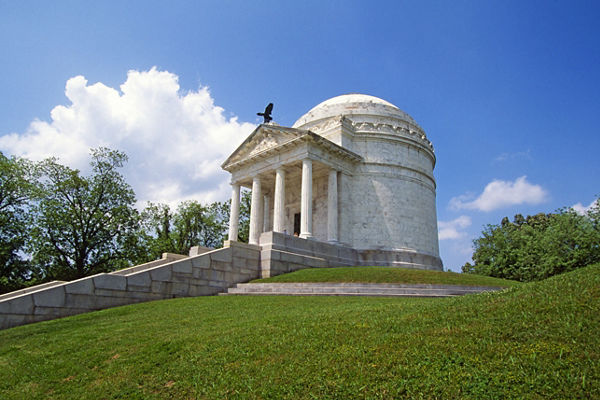 Historic white marble memorial under blue sky