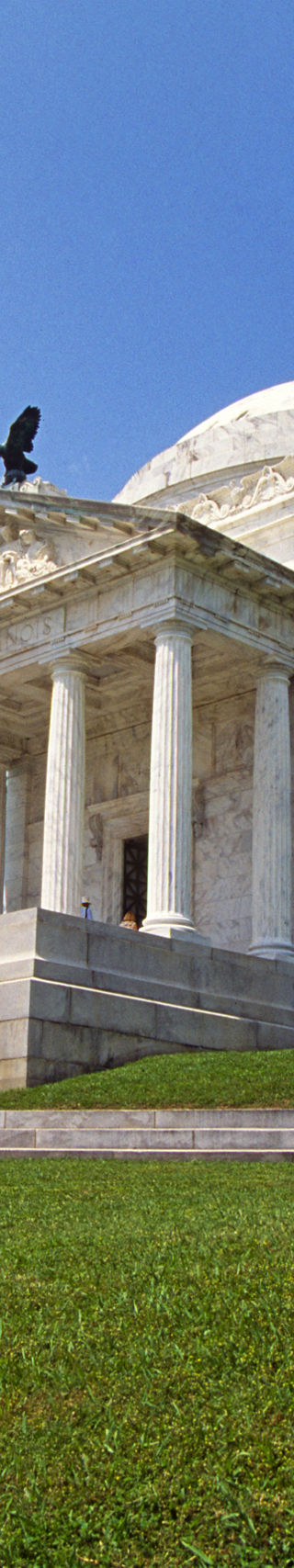 Historic white marble memorial under blue sky