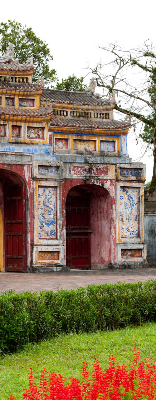 Historic gate with vibrant garden flowers