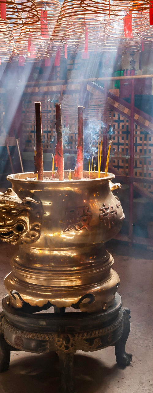 Sunbeams and Incense Smoke in Traditional Temple Interior