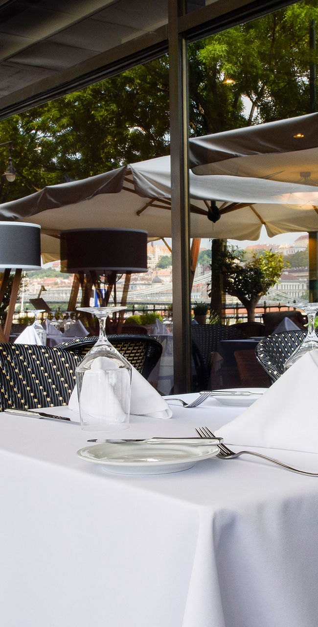 Outdoor dining area with white tablecloths