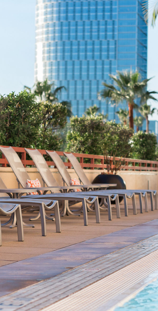 Rooftop pool with lounge chairs and city view