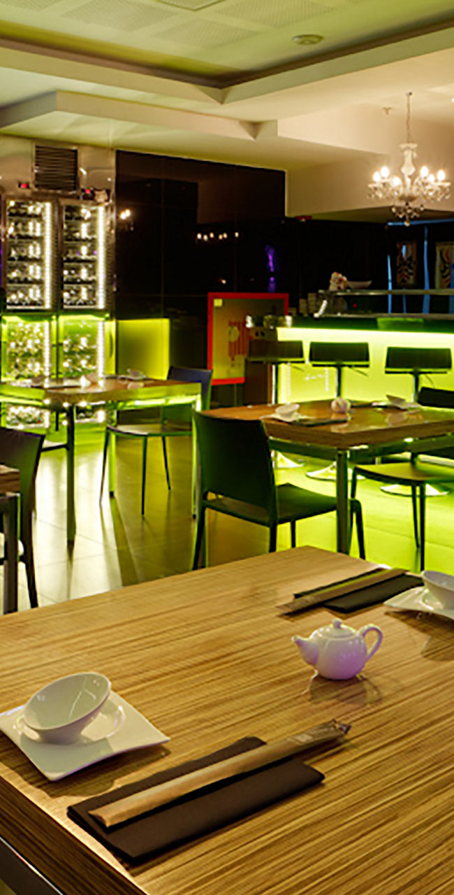 Modern restaurant with vibrant green lighting