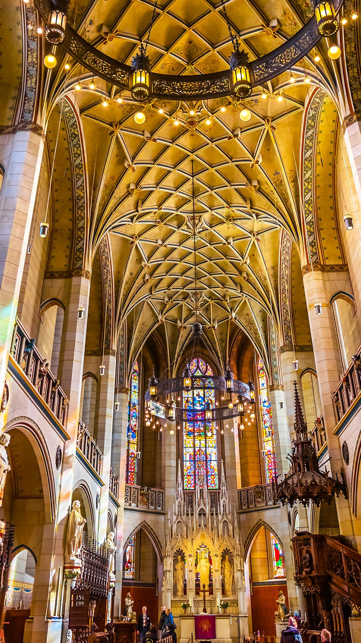 Colorful gothic cathedral interior with vaulted ceiling