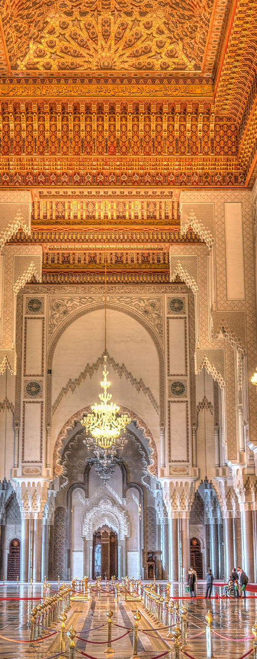 Grand mosque interior with ornate chandeliers