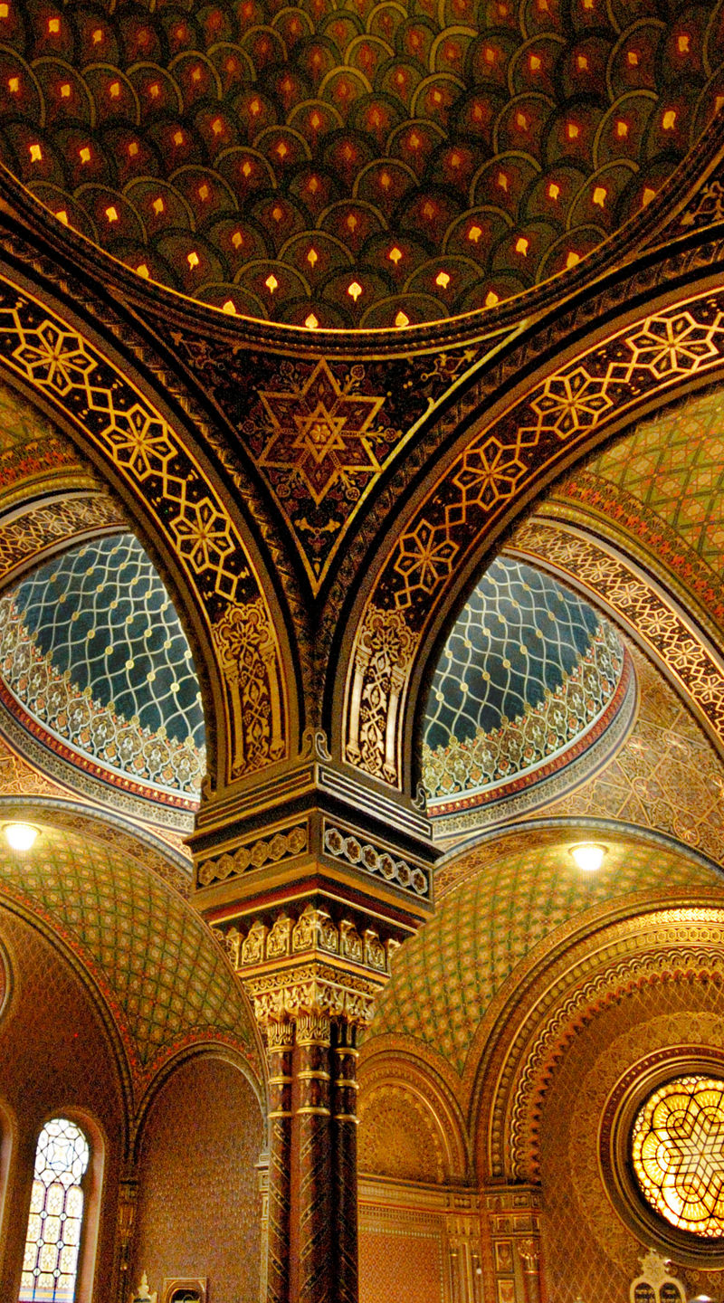 Ornate synagogue interior with visitors