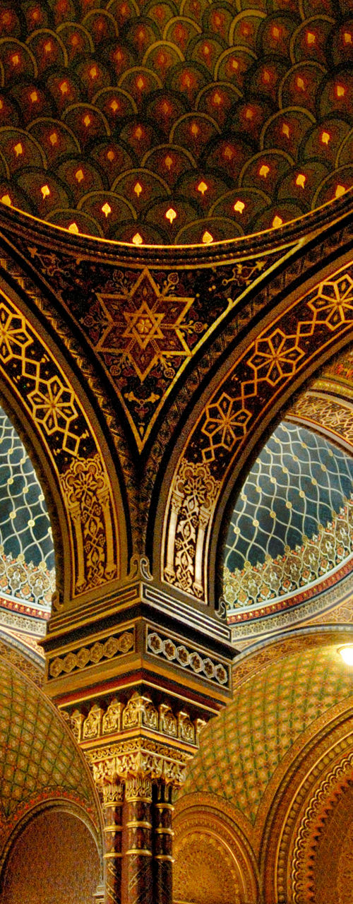 Ornate synagogue interior with visitors