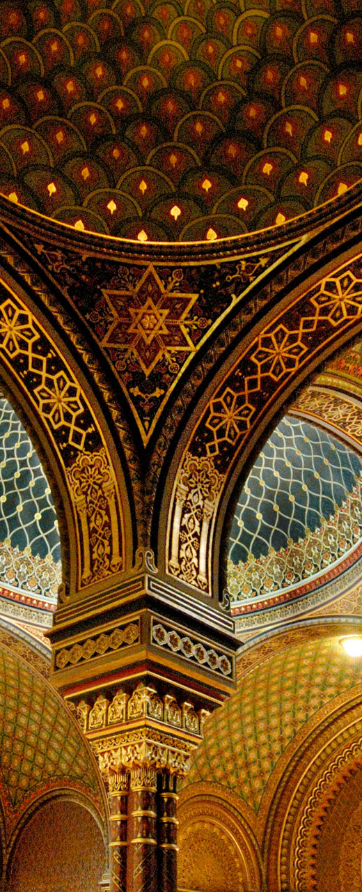 Ornate synagogue interior with visitors