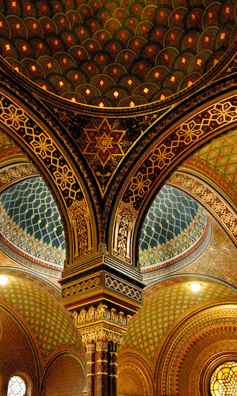 Ornate synagogue interior with visitors
