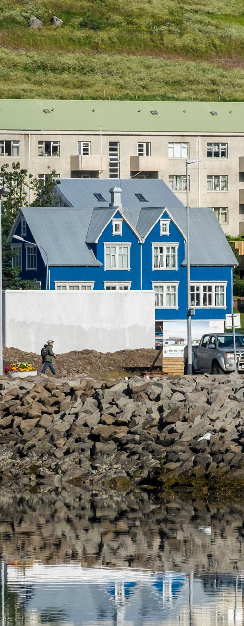 Colorful houses by a calm waterfront