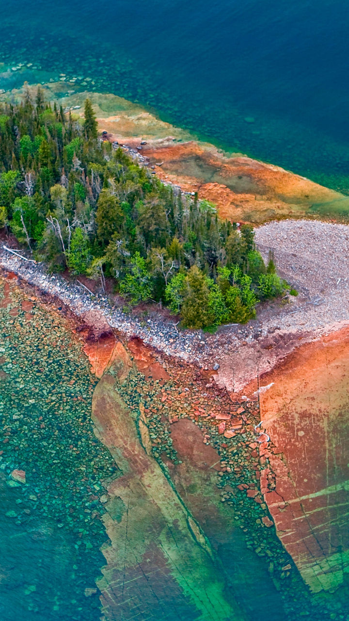 Aerial view of vibrant island in clear water