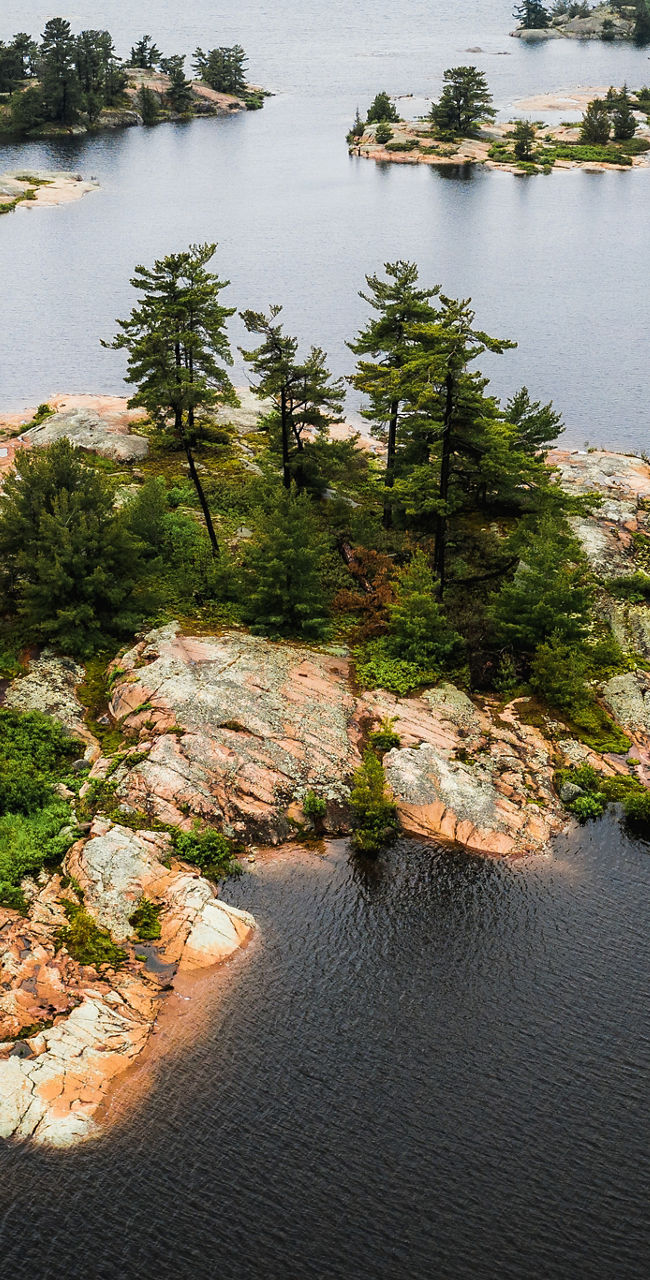 Scenic view of rocky islands in calm lake