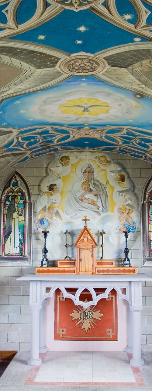 Ornate chapel interior with painted ceiling
