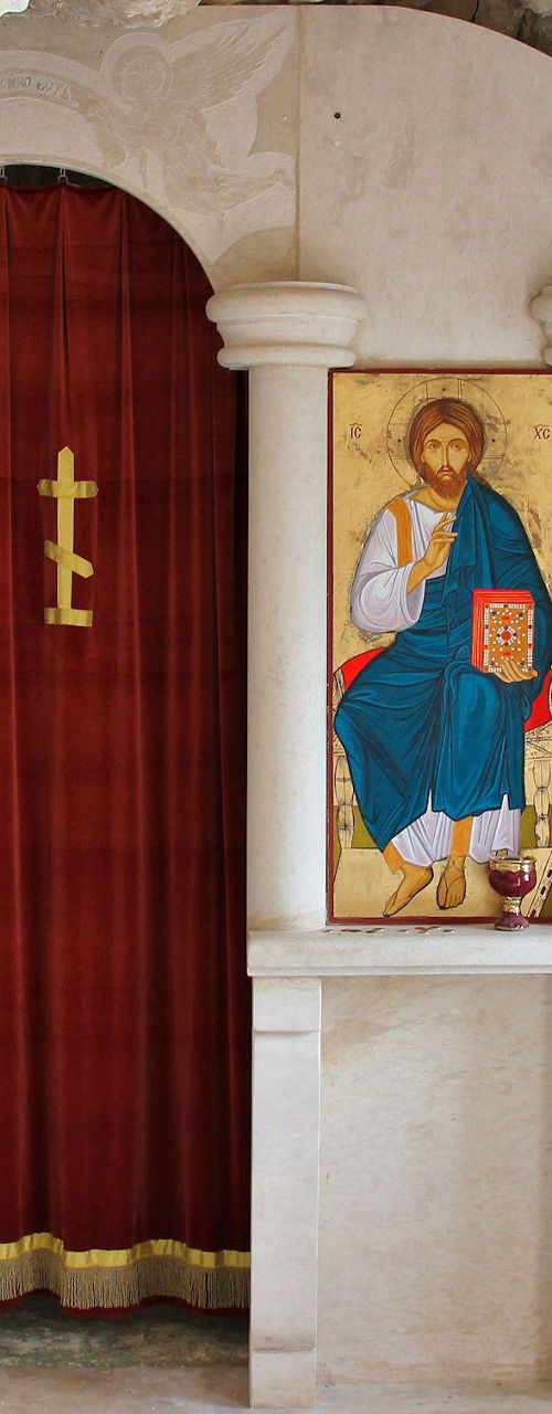 Small stone chapel with religious icons
