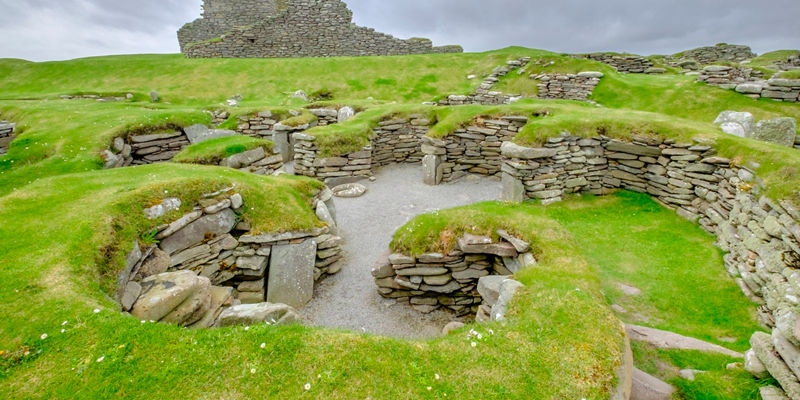 Ancient stone ruins on grassy landscape
