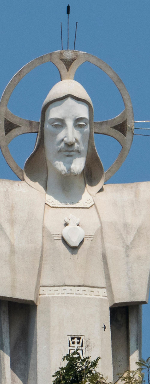 Large white statue with open arms