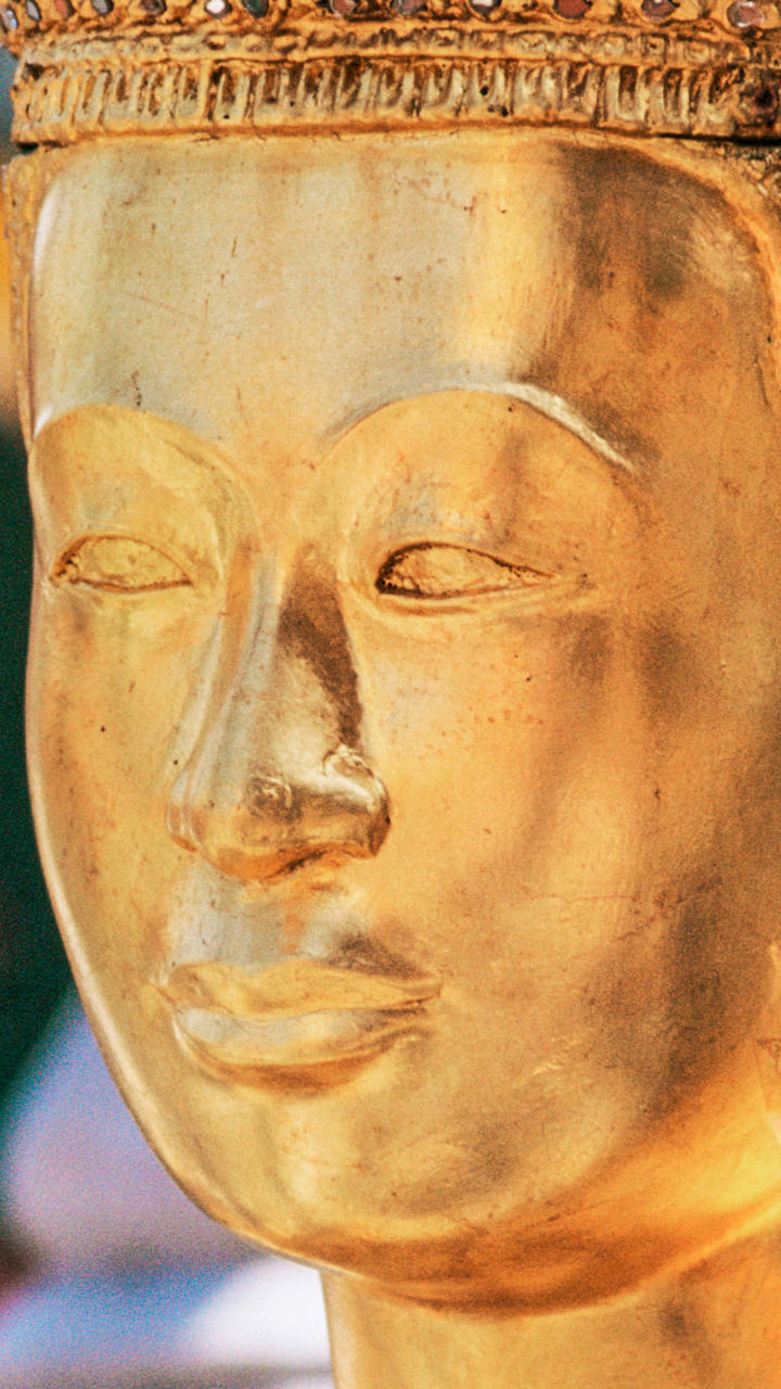 Golden Thai statue in ornate temple setting