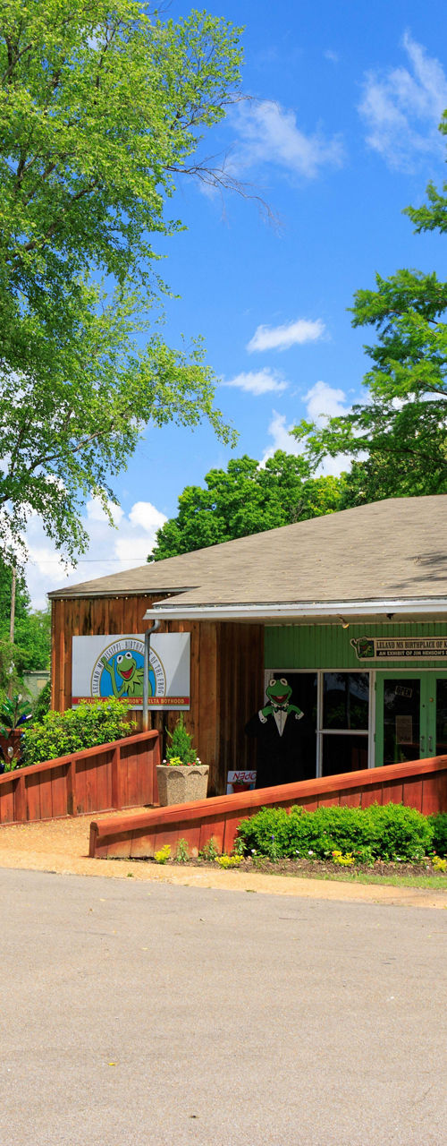 Visitor center building surrounded by lush green trees