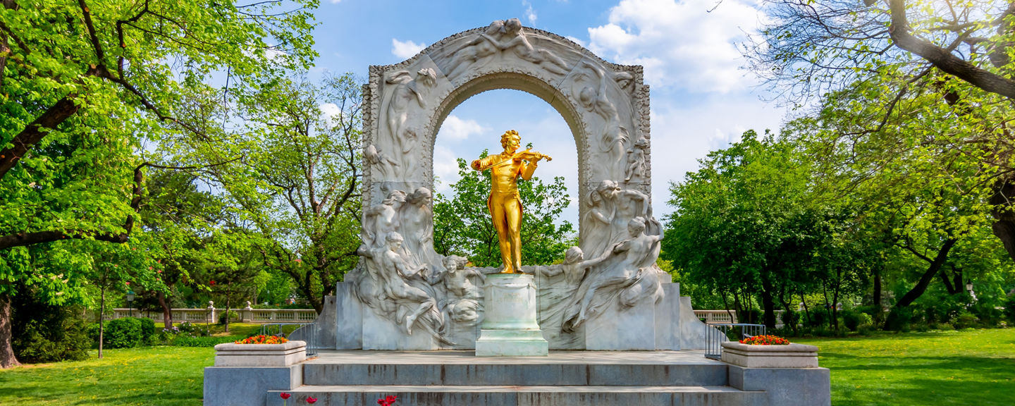 Golden musician monument in spring garden