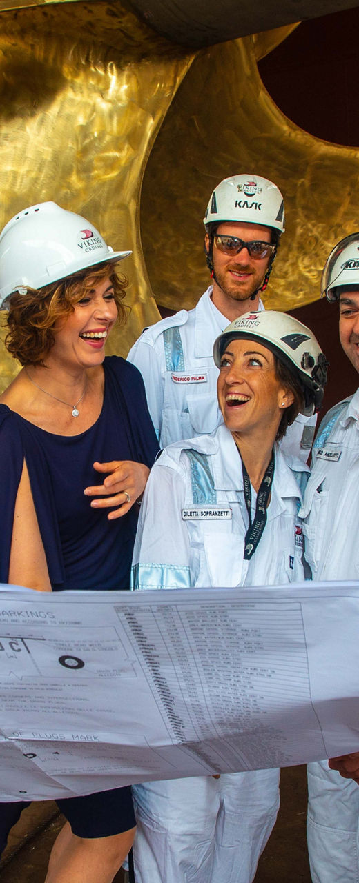 Engineers and supervisor review blueprints at shipyard