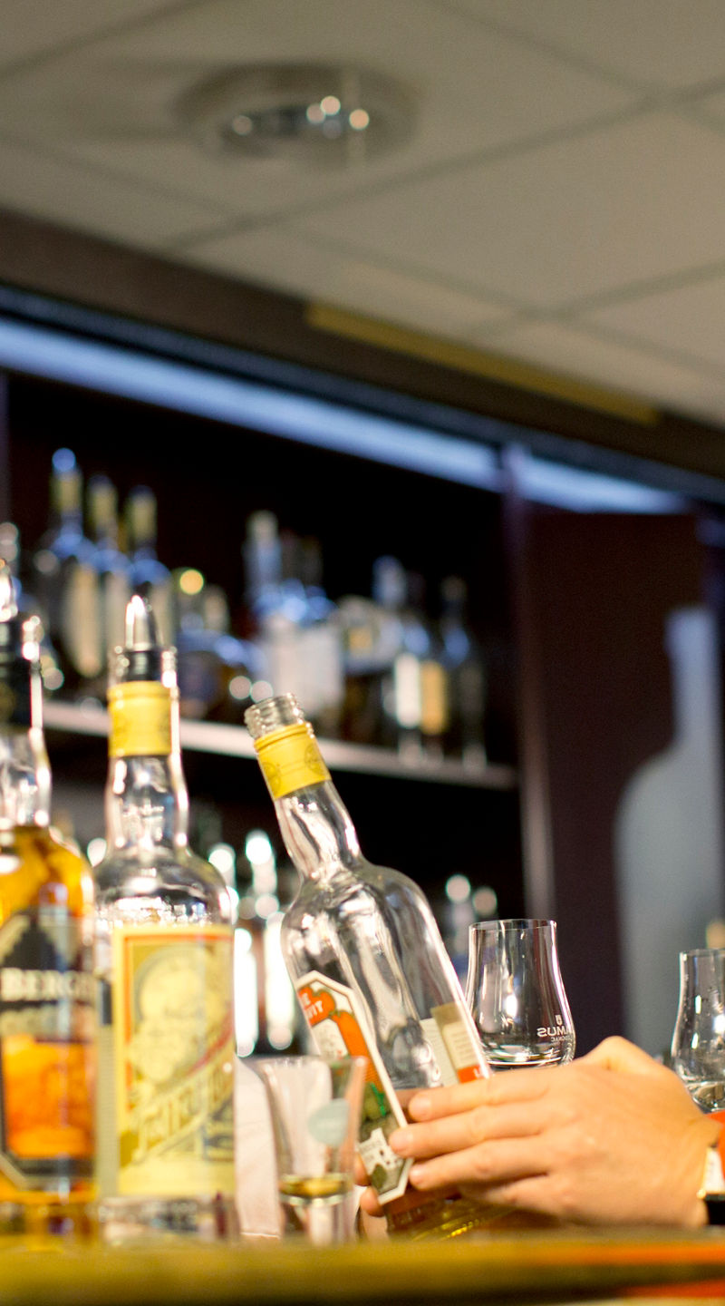 Bar setting with whiskey bottles displayed