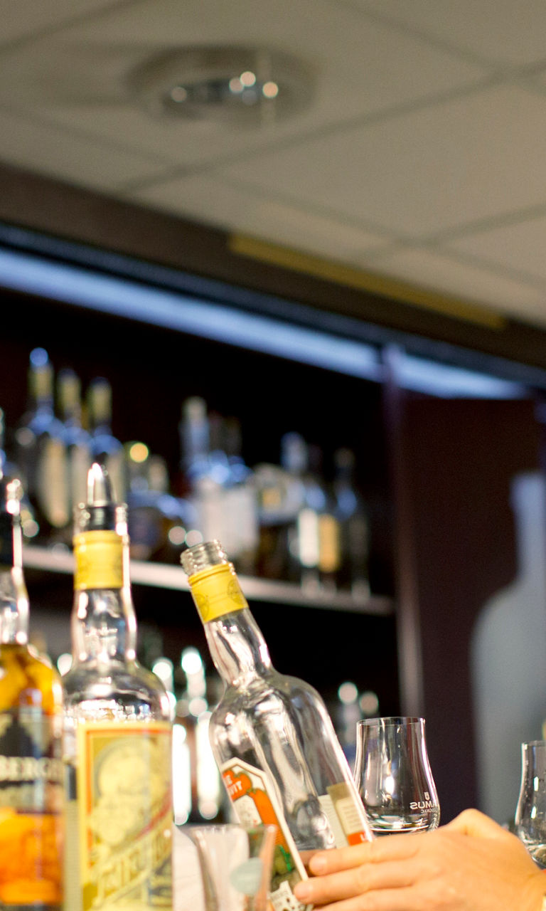 Bar setting with whiskey bottles displayed
